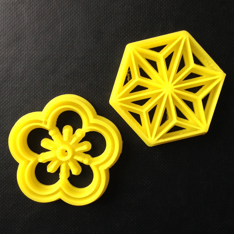 two 3D printed flower designs cookie stamps